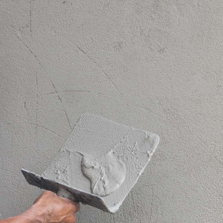 Sand cement render against acrylic render
